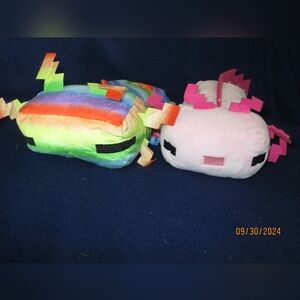 Pink and rainbow axilotl stuffies